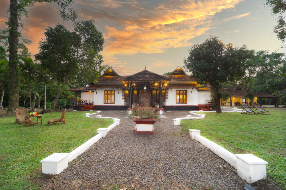 Traditional South Indian style house in Alappuzha with lawn, seating area, surrounded by lush nature