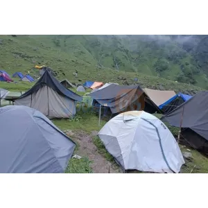 Glamping tents with lights and scenic Himalayan backdrop at Shree Narayan Tents & Camp 