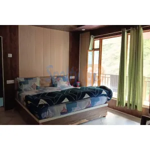 room with double bed and balcony views at Devlok Hotel in Gaurikund on Kedarnath Route