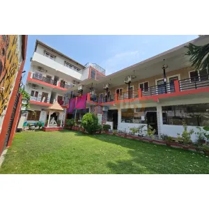 Front view of YoG1 Ashram with temple and lawn area in Rishikesh