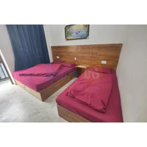 clean three beds room with simple furniture at Hotel Gayatri in Gaurikund on Kedarnath Route