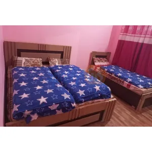 room with three beds at Hotel Mandakini in Janki Chatti, Yamnotri Marg