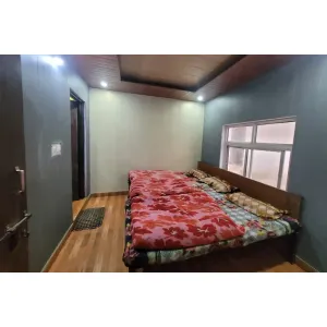family room with three beds and attached bathroom at Pataliputra House near Kedarnath