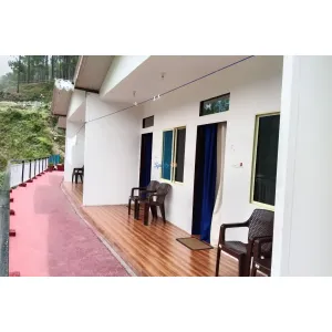 balcony corridor with sitting chairs at Hotel Garhwal Palace in Barkot