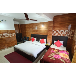 Standard low budget room featuring one double bed and one single bed