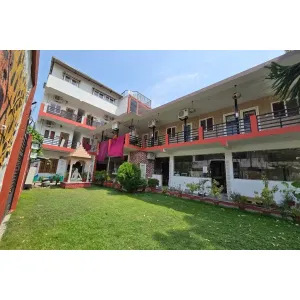 Front view of YoG1 Ashram with temple and lawn area in Rishikesh