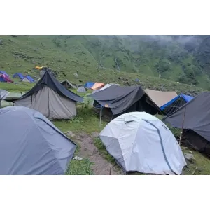 Glamping tents with lights and scenic Himalayan backdrop at Shree Narayan Tents & Camp