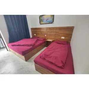 clean three beds room with simple furniture at Hotel Gayatri in Gaurikund on Kedarnath Route