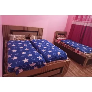 room with three beds at Hotel Mandakini in Janki Chatti, Yamnotri Marg